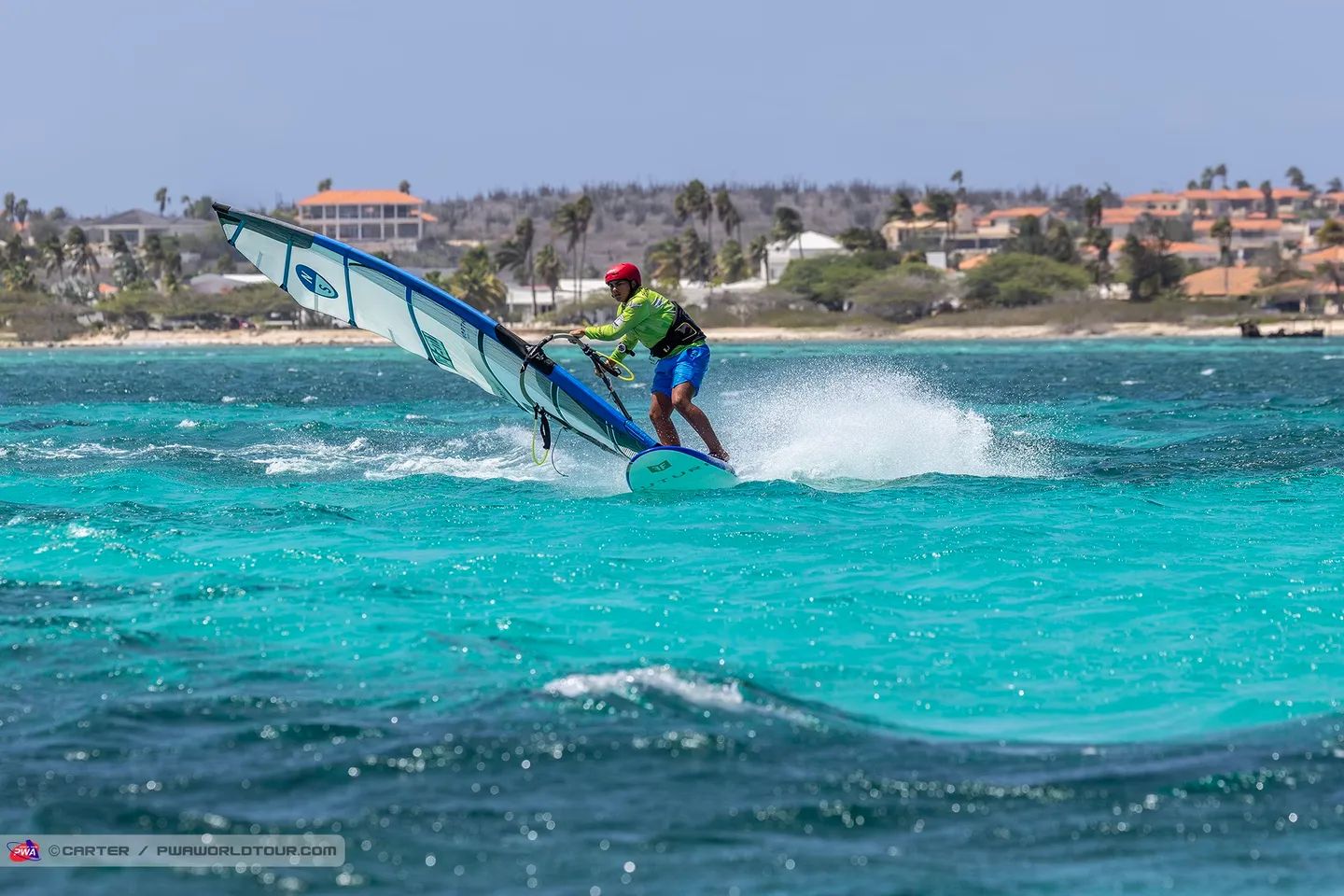 Carving across turquoise flatwater