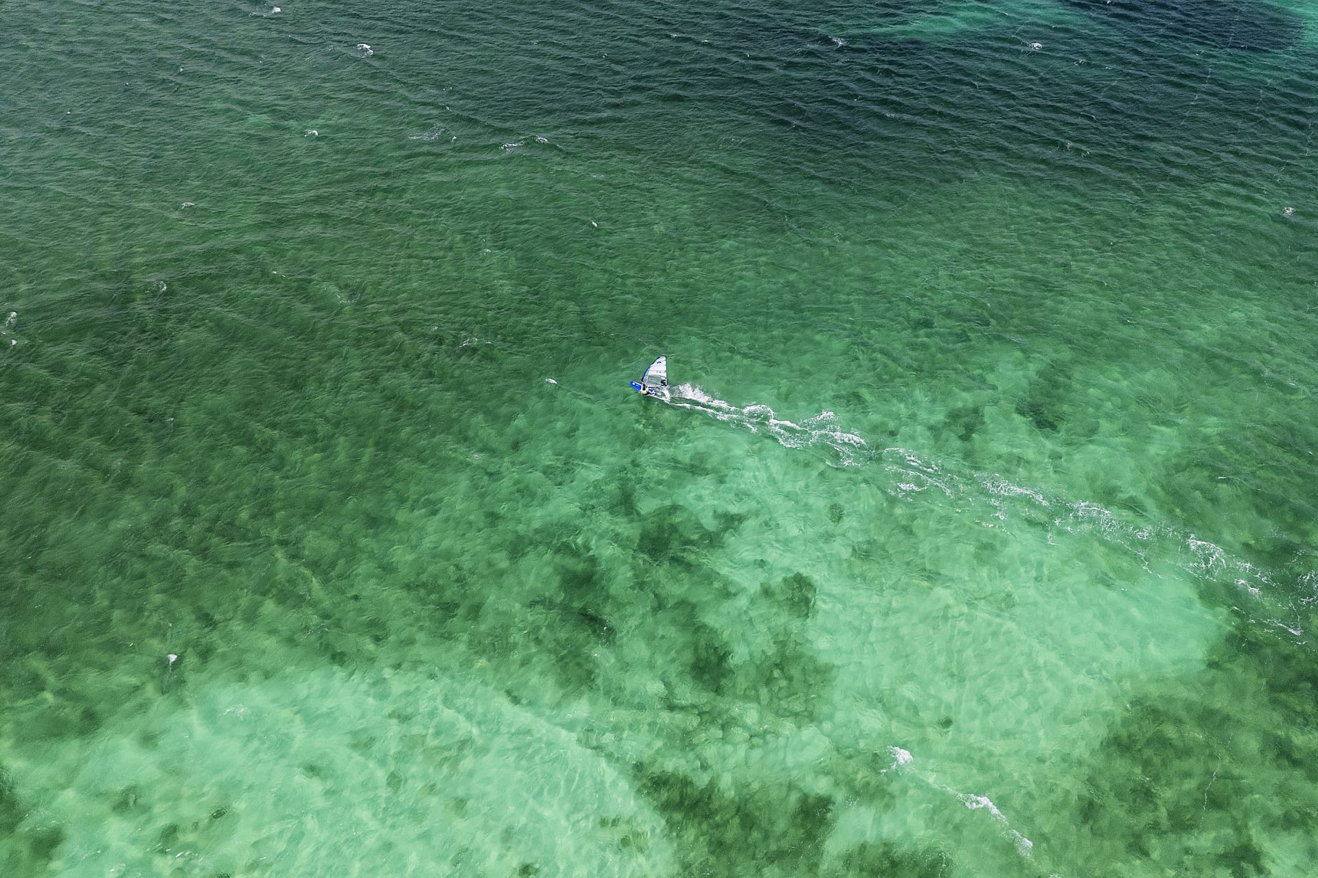 Aerial windsurfer in shallow water