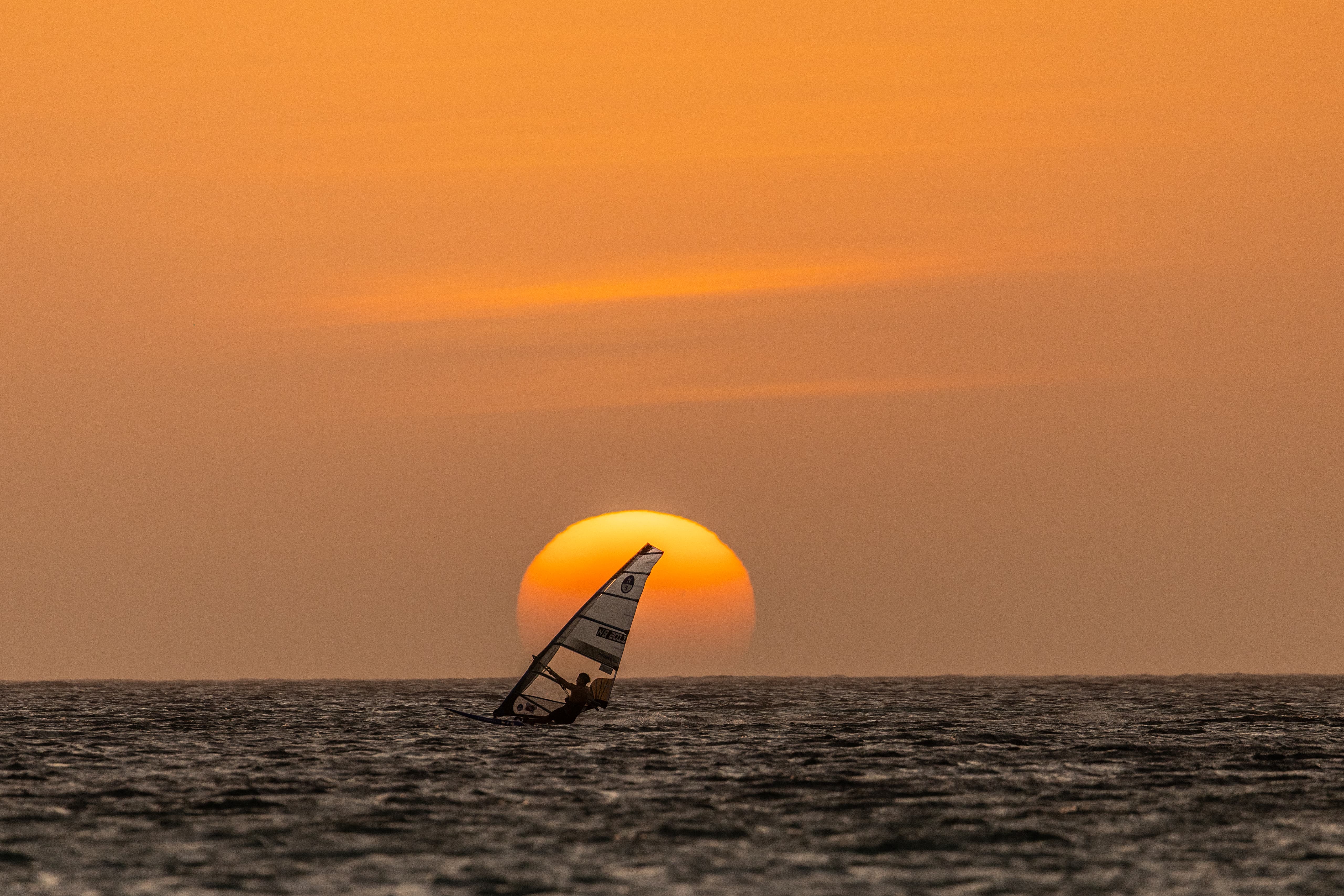 Young windsurfer at sunset on Bonaire